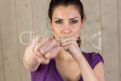 Portrait of beautiful woman punching