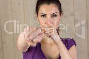 Portrait of beautiful woman punching