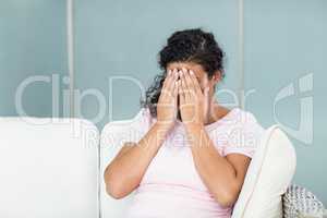 Upset woman with hands on face
