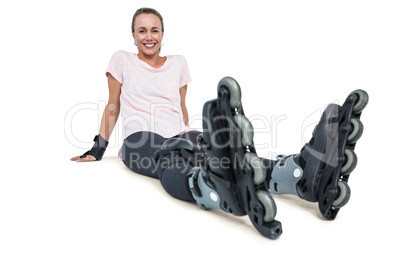 Portrait of cheerful female inline skater relaxing