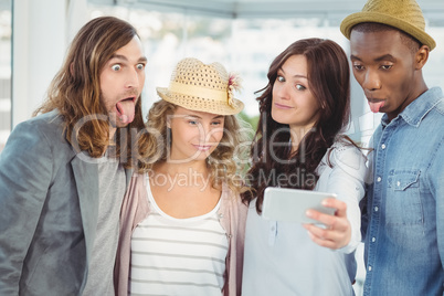 Business team making face while taking selfie