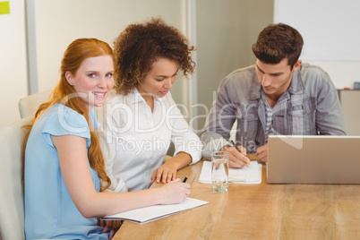 Smiling businesswoman with colleagues in meeting