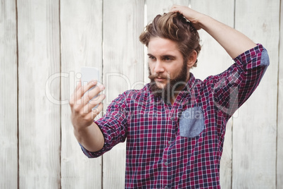 Confident hipster taking selfie