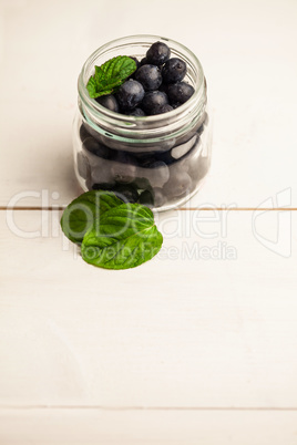 Glass jar of fresh blueberries