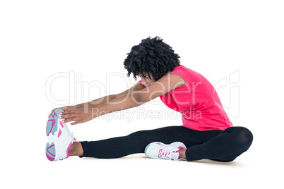 Young woman touching toes while exercising