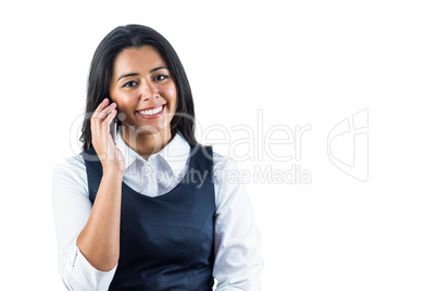 Smiling woman using her smartphone to make a call