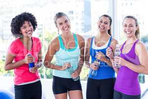 Portrait of fit women holding water bottle