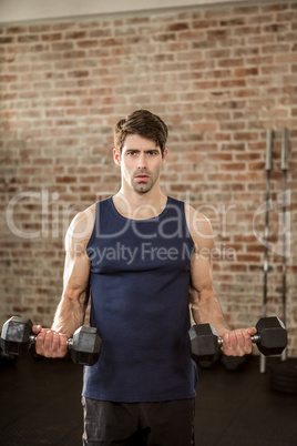 Portrait of a man lifting dumbbells