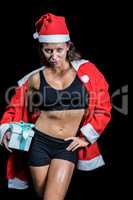 Portrait of confident athlete in Christmas costume while holding