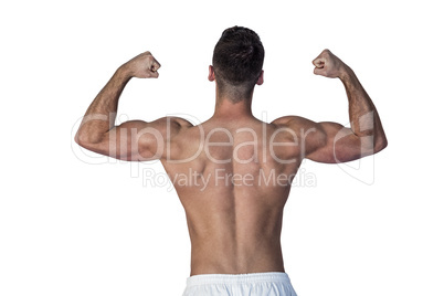 Rear view of muscular man showing biceps