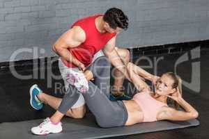 Muscular couple doing abdominal exercises