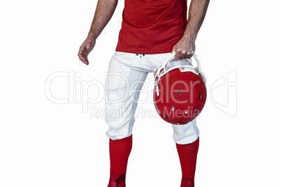 Midsection of athlete holding rugby helmet