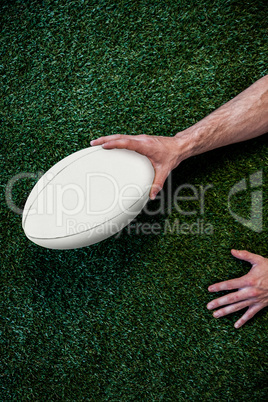 Cropped image of a man holding rugby ball