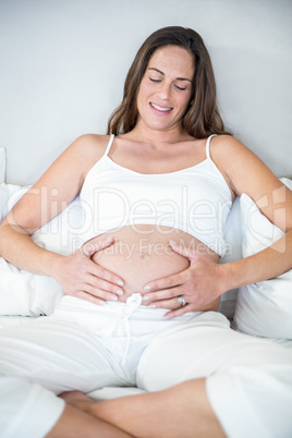 Happy woman with hands on belly