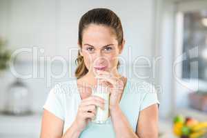 Portrait of happy woman drinking juice