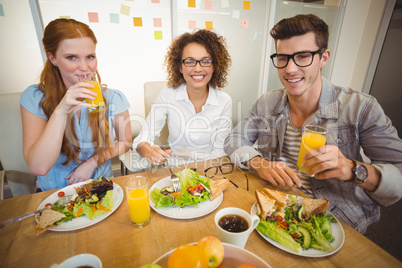 Smiling business people having breakfast