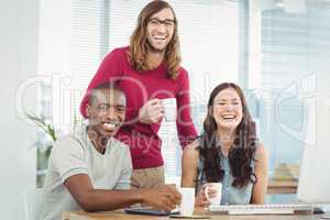 Portrait of smiling business people holding coffee cups