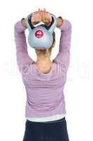 Rear view of woman exercising with kettlebell