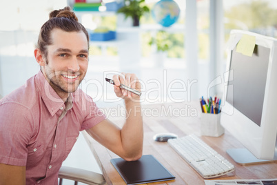 Portrait of confident businessman holding electronic cigarette