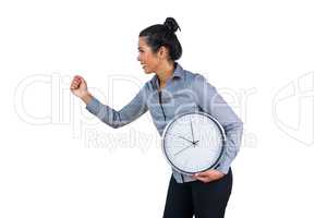 Smiling woman holding a large clock