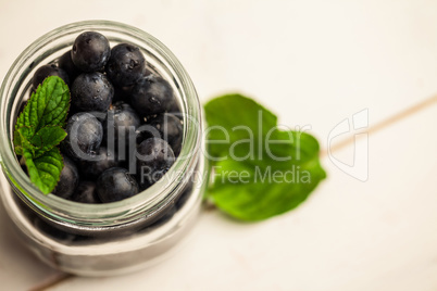 Glass jar of fresh blueberries
