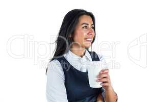 Smiling woman holding a paper cup
