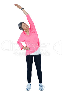 Mature woman looking up while stretching