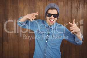 Happy hipster showing rock and roll hand sign