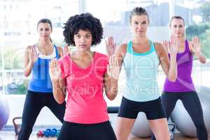 Women exercising with trainer