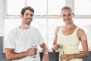 Couple holding bottle of water posing