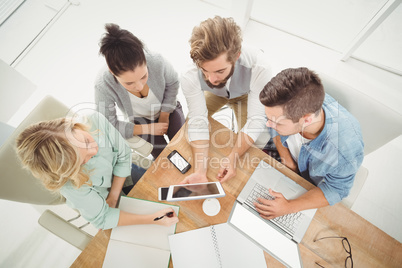 Overhead view of business people with digital tablet in office