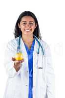 Smiling doctor with an apple in her hand