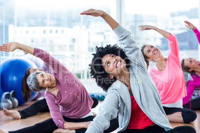 Happy women exercising while arms raised