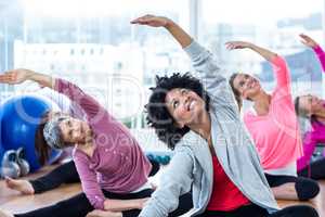 Happy women exercising while arms raised