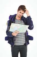 Man scratching head while looking in map
