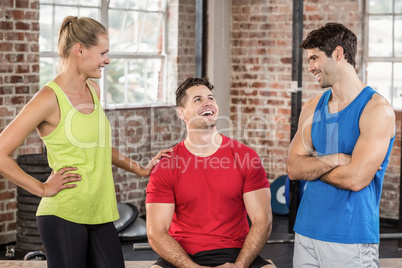 Fit smiling people discussing together