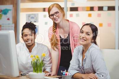 Portrait of smiling businesswoman with colleagues