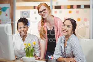 Portrait of smiling businesswoman with colleagues