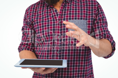 Mid section of man gesturing while holding digital tablet