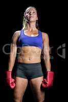 Female athlete standing with gloves