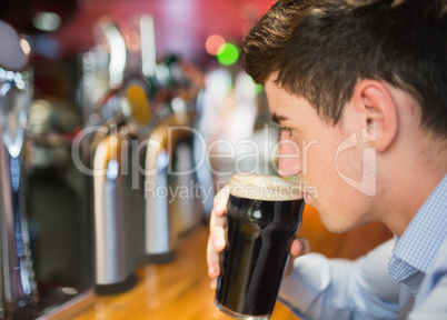 Man with drink at bar counter