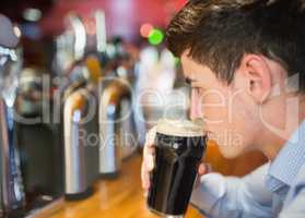 Man with drink at bar counter