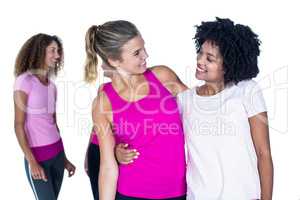 Cheerful women with arms around