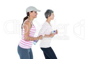 Side view of happy women with bottle jogging