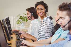 Portrait of smiling businesswoman in call center