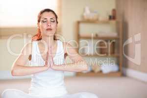 Woman meditating with joined hands