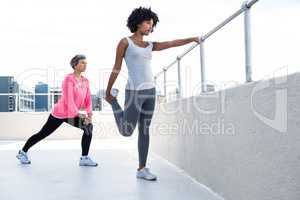 Woman exercising with female friend