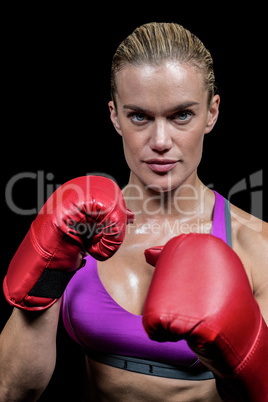 Portrait of female boxer with gloves