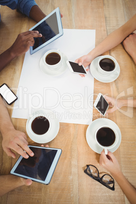 Overhead view of people using smartphones and digital tablet