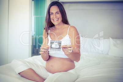 Portrait of happy woman with ultrasound scan
